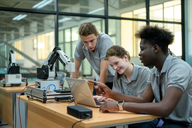 A group of high school students working on a robotics project in a well-equipped lab. The students are collaborating and problem-solving as they assemble and program a robot. The atmosphere is one of teamwork and innovation.