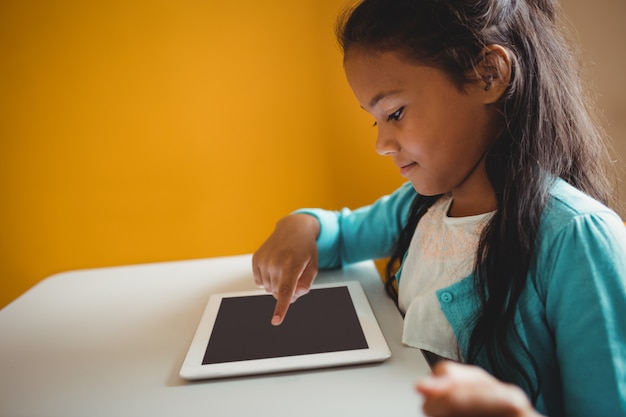 A student using a tablet with accessibility features enabled, such as screen reader and adjustable font size. The student is engaging with educational content in a comfortable and accessible manner.
