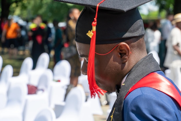 A high school graduation ceremony showing diverse students in caps and gowns, signifying the culmination of years of education and the long-term impact of early childhood education.
