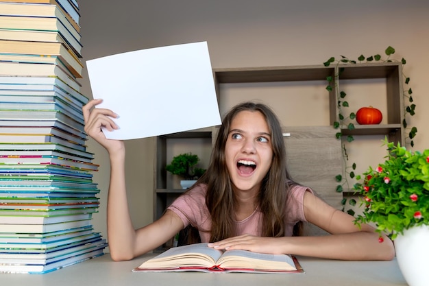 A photo of a school voucher laying on top of textbooks, with a happy student blurred in the background.
