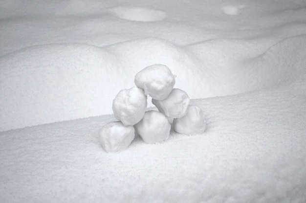 A visual representation of a snowball rolling down a hill, growing larger as it accumulates more snow, symbolizing the increasing payments towards larger debts in the debt snowball method.