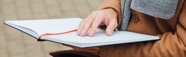 A close-up of a person writing down notes in a notebook during a negotiation. The focus is on their hand and the notepad, showing details such as calculations and bullet points, illustrating preparation and strategic planning.