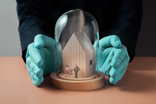 A house in an insurance policy shield demonstrates the importance of protecting your physical assets through insurance.