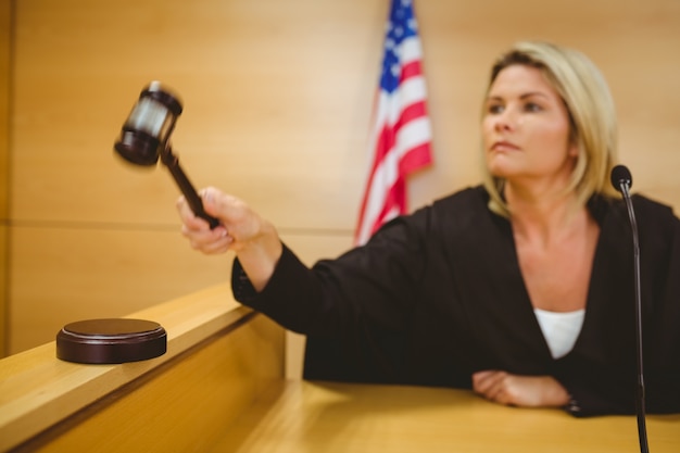 A gavel hitting a sound block in a congressional hearing room, focusing on immigration reform.