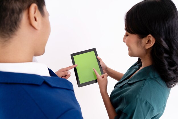 A patient using a tablet to compare prices for medical procedures at different hospitals, illustrating the concept of price transparency in healthcare.