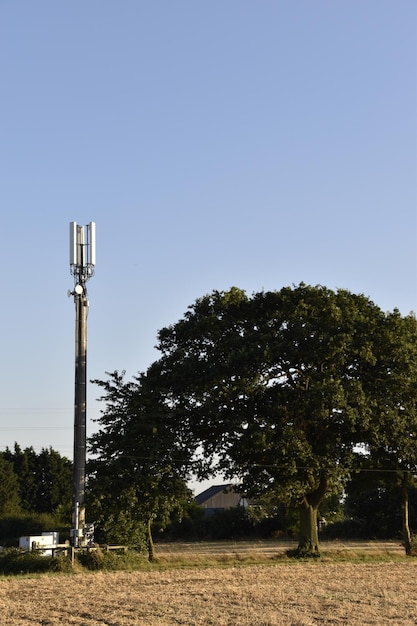 A wide shot of a rural community with newly installed broadband internet towers, showcasing the expansion of internet access to previously underserved areas and highlighting the potential for economic development and improved quality of life.