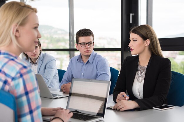 Image of college administrators in a meeting, looking concerned and contemplative, with documents related to admissions policies spread across the table. The atmosphere should suggest serious deliberation and strategic planning.