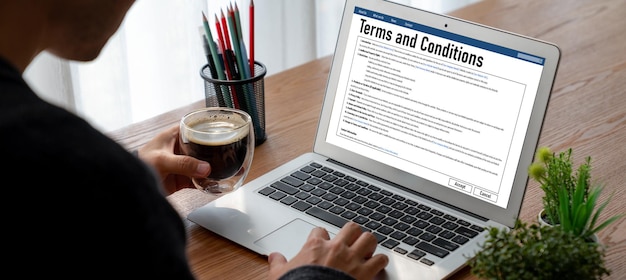 A laptop screen displaying a resume template with highlighted sections showcasing transferable skills and industry-specific achievements. A pair of glasses rests on the keyboard, suggesting careful review and attention to detail.