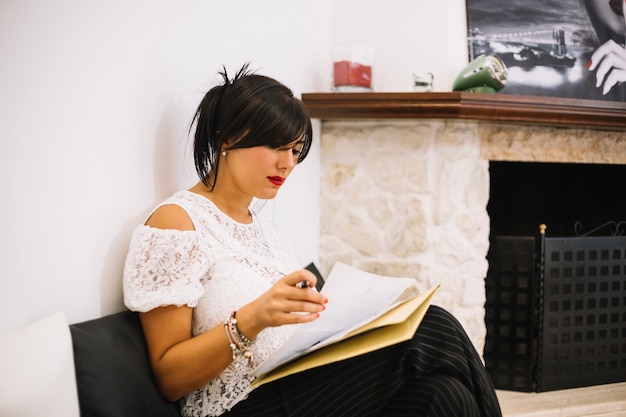 An introvert intently listening to a speaker at a seminar, taking notes in a journal. The focus is on their engaged expression and the act of thoughtful observation, with soft, natural lighting highlighting their concentration.