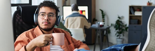 An introvert sitting comfortably at a desk, participating in a virtual networking event on their laptop. The scene is a cozy home office with soft lighting, emphasizing their ease and focus in the digital environment.
