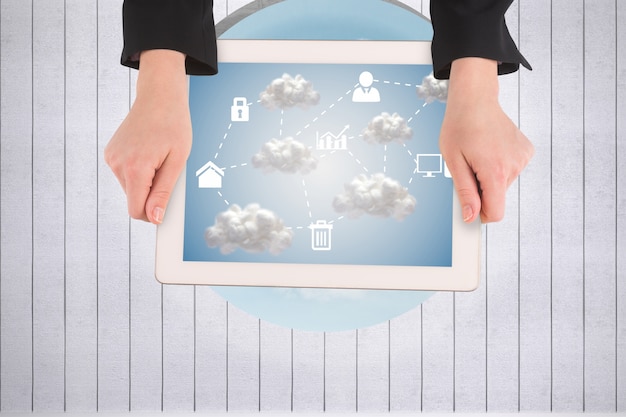 An architect designing cloud infrastructure layouts, with a tablet displaying a complex cloud architecture diagram.
