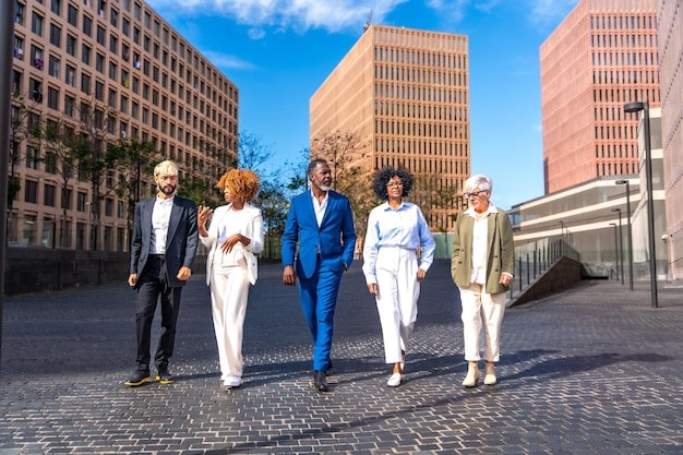 A diverse group of people standing in front of a building labeled 
