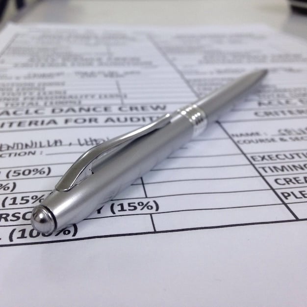 A close-up shot of a filled-out tax form with a pen resting on top. The form is clearly labeled 