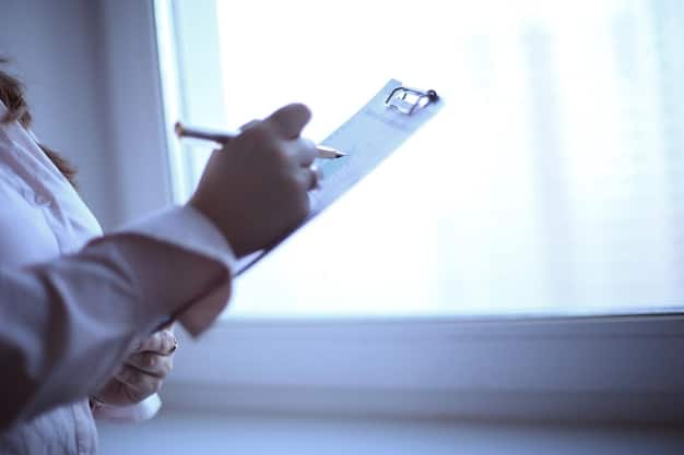 A close-up shot of a hand holding a Medicaid enrollment form, with a pen poised to fill it out. The background is blurred, suggesting a busy clinic or social services office.