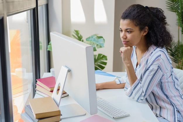 A person sitting at a desk, looking thoughtfully at a laptop screen displaying a student loan application form. The image should evoke a sense of determination and focus on the task at hand.