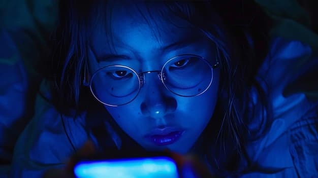 A close-up shot of a student's face illuminated by the blue light of a smartphone, showing a mixture of concentration and fatigue. The background is blurred, focusing on the student's expression and the smartphone screen.