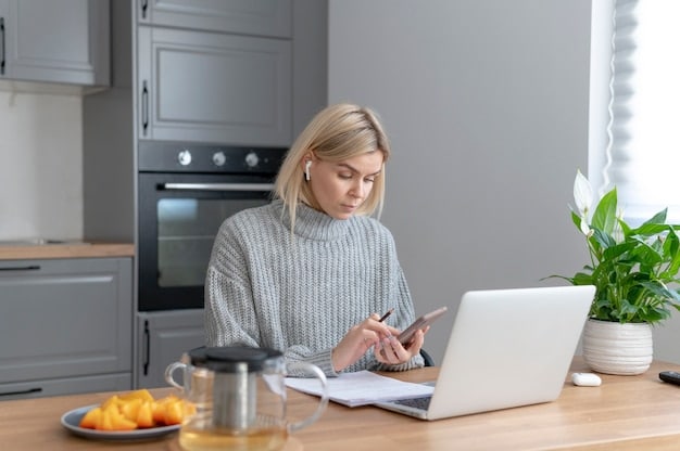 A person reviewing financial documents at a kitchen table, highlighting the importance of thorough preparation and understanding of income and repayment plan details for loan forgiveness eligibility.