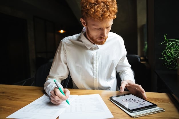 A person filling out a student loan forgiveness application form with a pen, surrounded by financial documents and a calculator.